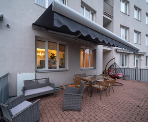 A terrace of an apartment in a multi-apartment building with a recreation area.