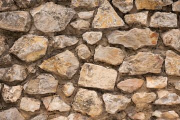 Irregular stone masonry wall texture background
