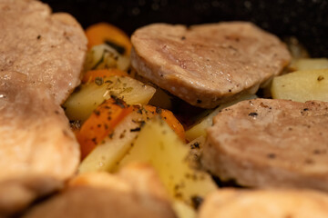 Close-up of roasted pork and seasoned vegetables
