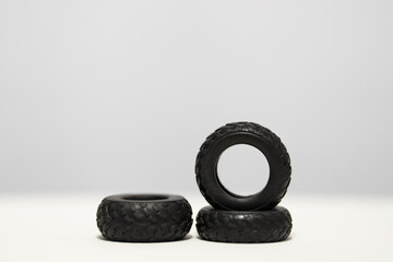 Rubber car tire scale models photographed on a white background, showing realistic tread patterns and miniature detailing
