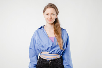 Young woman in casual clothing looks straight at the camera, creating a friendly impression, perfect for social media graphics, website headers, and advertising campaigns