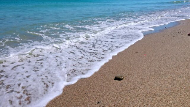 Beautiful view of Aegean Sea waves with natural stereo sound on pebbled beach background. Kos. Greece.