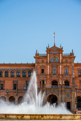 Majestic Fountain and Historic Architecture of Plaza de España in Seville Under a Bright Clear Blue Sky © Junus