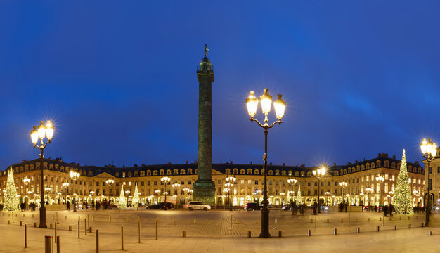 Vendome column with statue of Napoleon Bonaparte, on the Place Vendome decorated for Christmas at night , Paris, France. Vendome column has 425 spiraling bas-relief bronze plates were made out of