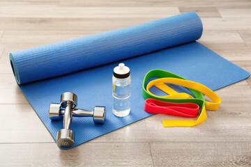 A diverse collection of workout equipment designed specifically for home fitness routines, featuring weights and bands