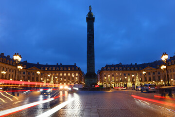 Vendome column with statue of Napoleon Bonaparte, on the Place Vendome decorated for Christmas at night , Paris, France. Vendome column has 425 spiraling bas-relief bronze plates were made out of