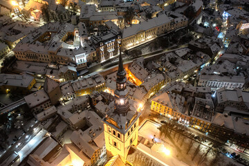 Aerial night View of Tallinn in winter, roofs are covered with snow, Christmas mood