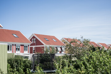 Row of colorful Scandinavian houses with red roofs.