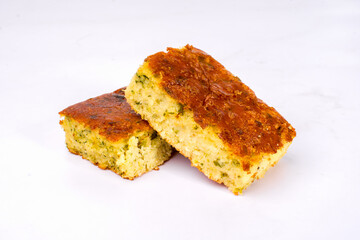 Homemade Cornbread Squares with Herbs on White Background. Great for bakery ads and homemade cuisine promotions.