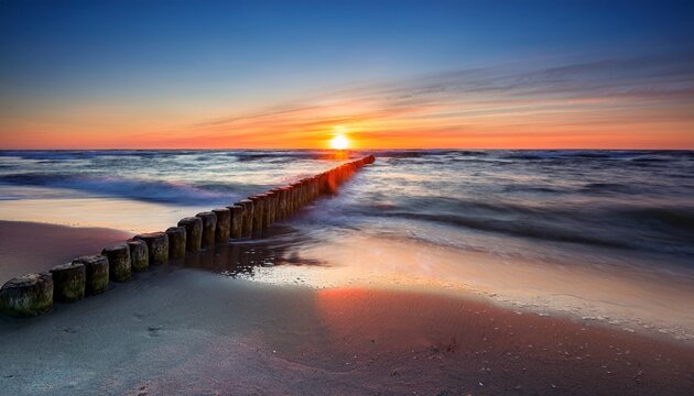 Sunset On The Baltic Sea Beach And Old Wooden Breakwater - Powered by Adobe