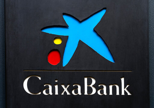 Seville, Spain; October 15, 2025; Close-up of Caixabank logo sign on branch facade.