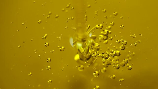 Olive oil jet pours elegantly with visible air bubbles