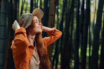 woman smile hat bamboo forest nature redhead happiness young female portrait standing among tall...
