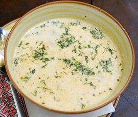 Fresh homemade mushroom soup in ceramic bowl isolated on white, top view. High quality photo