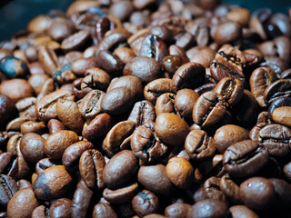 Freshly roasted coffee beans displayed in a close-up view with rich textures and colors for coffee lovers