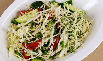 Vegetarian salad. Spring vegan salad with cabbage, cucumber, green onion and parsley. Top view, flat lay, overhead. High quality photo