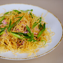 Spicy Potato Jalapeno Salad with Bacon, Green Onions and Mayo Close-up in Bowl on Table. Horizontal . salad with fried potatoes and green onions