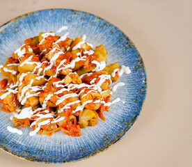 Traditional stuffed squash and cabbage rolls on white plate on blue bright background. Famous traditional Middle East, Egyptian, Asian cuisine. Mahshi or mahshy. mini cabbage rolls