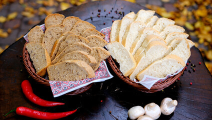 Basket with French bread, traditional Brazilian bread. On a stump in the forest pieces of bread in...