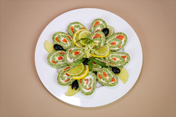 spinach pancakes with filling on a white plate macro photo. spinach pancakes with red fish