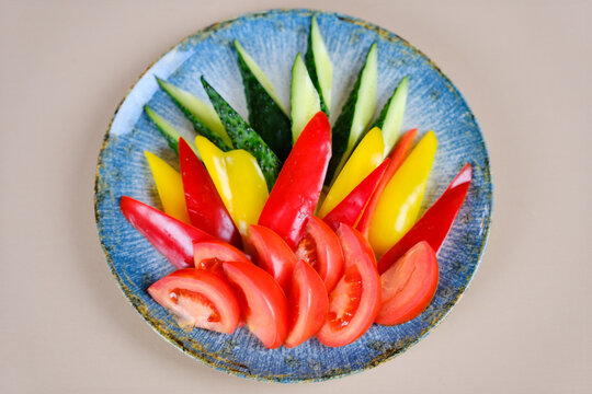 A colander filled with assorted fresh ripe tomatoes, red, heirloom, beef heart, pear shaped and cherry varieties with fresh basil. Rustic, farm to table aesthetic, harvest and cooking.