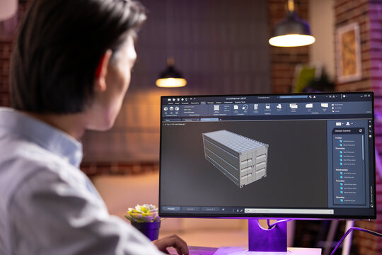 Focused person designing container prototype using professional creative software in home office. Male entrepreneur working remotely on innovations and client projects product development.