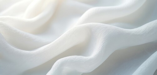 Obraz premium Close up photo of soft white fabric with waves. Delicate textile material has elegant texture. Light and shadows create a calm background. Smooth flowing cloth.