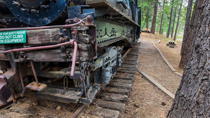 Sierra Nevada Logging Museum looking a a vintage steam locomotive used to move timber from the mountains tho the sawmills showing the undercarriage of the engine