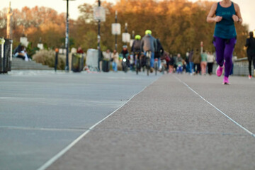 Diverse Group of People in Bordeaux Engaging in Outdoor Physical Activities like Running, Jogging, and Cycling on Urban Pathway in Autumn for Health and Fitness