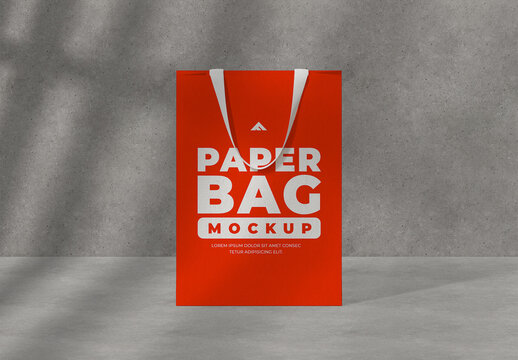 Tall Paper Shopping Bag Mockup with Dramatic Shadow on Textured Wall