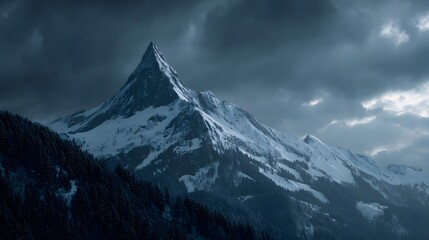 Majestic Snow-Capped Mountain Peak Under Dramatic Cloudy Sky.