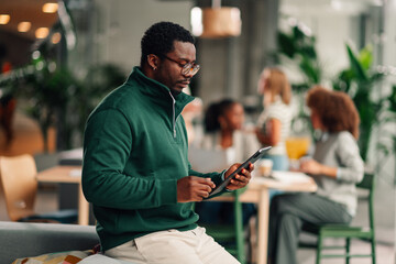 African american man using tablet in modern office