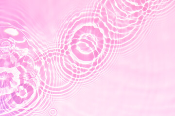 Pink water bubbles on the surface ripples. Defocus blurred transparent pink colored clear calm...