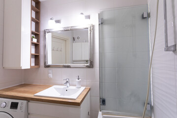 This is a beautifully designed modern bathroom interior featuring a sleek shower and stylish vanity