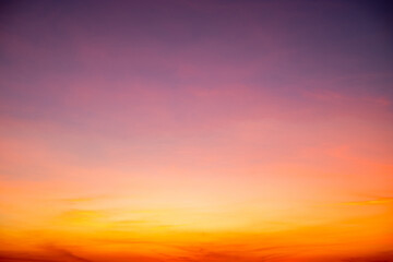 Sunset or sunrise sky with a vibrant gradient of orange, gold, and soft blue. Clear atmosphere with wispy clouds. Peaceful, natural light background. hope, freedom, new day Concepts, Vertical