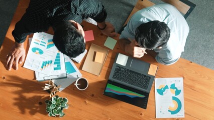 Top aerial view of business team working together to analysis data by using laptop on meeting...