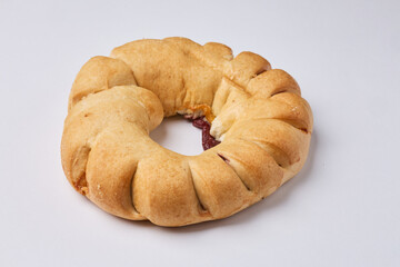 Baked sweet pastry ring with fruit jam filling