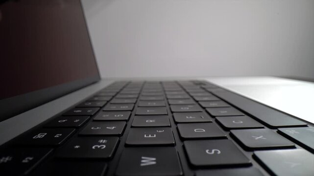 Sliding camera view along a laptop keyboard