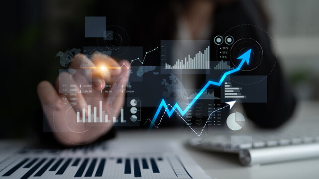 A businesswoman using technology to analyze data trends in a modern office, showcasing virtual graphs that illustrate growth metrics and strategic insights. Scalp - Powered by Adobe