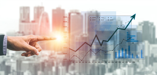 A close-up of a hand pointing at a rising graph symbolizing business growth against a blurred cityscape background, illustrating financial success and market potential. Scalp