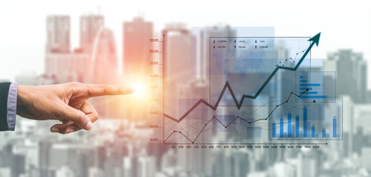 A close-up of a hand pointing at a rising graph symbolizing business growth against a blurred cityscape background, illustrating financial success and market potential. Scalp