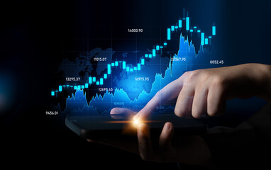 Close-up of a hand interacting with a smartphone displaying a financial market graph, highlighting trends and data analysis in a digital economy. Scalp