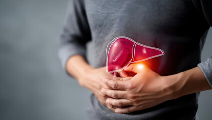 A person experiencing abdominal discomfort, highlighting the liver's importance in overall health and wellness.