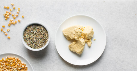 Overhead view of corn millet and nigerian akamu or pap, process of making akamu, flatlay of process of making nigerian akamu ogi pap or corn pudding