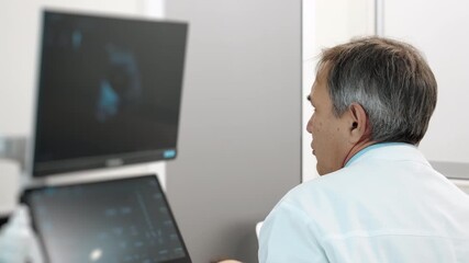 Medical doctor reviewing ultrasound scan results on monitor in modern clinic, diagnostic evaluation and healthcare imaging process indoors. - Powered by Adobe