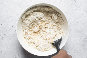 nigerian egg roll dough being mixed in a white bowl, process of making egg rolls