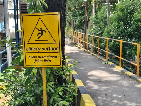 Slippery Surface Warning Sign near Walkway Safety Awareness
