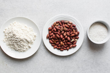 overhead view of mise en place of ingredients for making coated peanuts, process of making nigerian coated peanuts or cracker nut