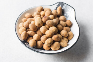 Coated peanuts or cracker peanuts on a white granite countertop