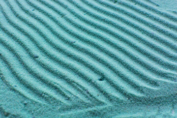 close up view of textured blue sand background, beautiful sand texture, overhead view of zen pattern drawn in blue sand, Top view of fine grain texture